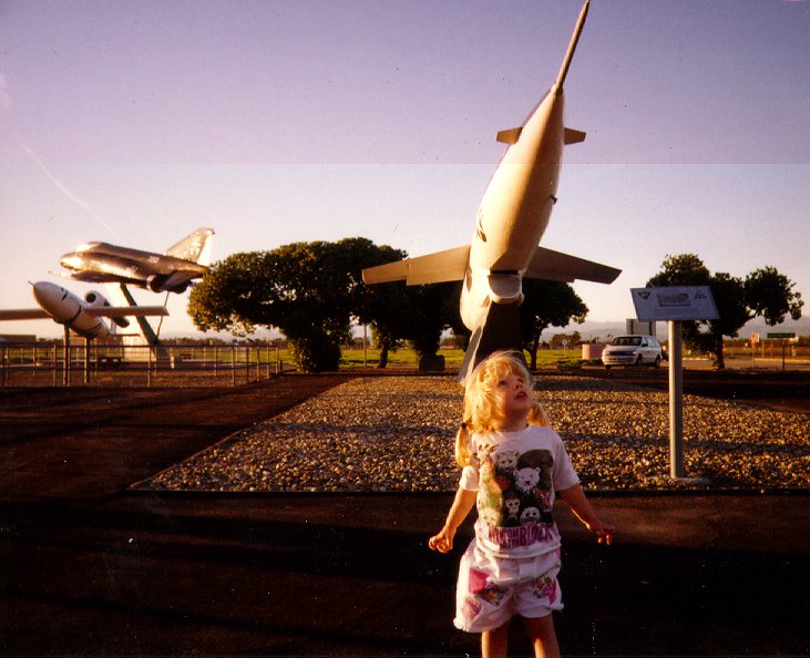 487x396 jpg image of a little girl and some rockets