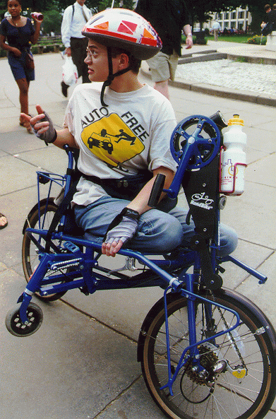 [PHOTO: Jen on handbike, stopped]