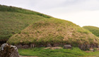 Small mouns surround a large mound at Knowth