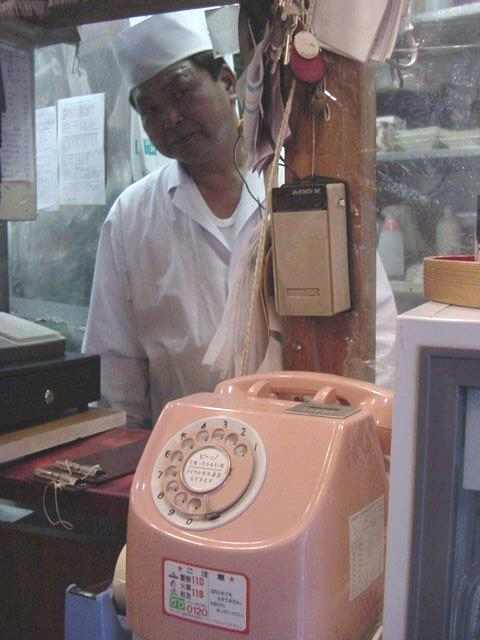 Pink phone in the sushi shop.