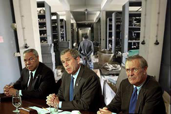 The
US braintrust, Powell, Bush, and Rumsfeld looking
self-satisfied before the destroyed inside of the
greatest museum of Mesopotamian artifacts.