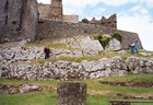 Pam standing at the base of the  Rock of Cashel